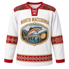 Load image into Gallery viewer, North Macedonia Original Hockey Jersey in Linen Embroidery White, front view – folk cross-stitch embroidery yoke and pearl-ringed Lake Ohrid trout crest in ornate detailed artwork, custom name and number