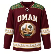 Load image into Gallery viewer, Oman Original Hockey Jersey in Nizwa Maroon, front view – kumma-embroidery yoke and octagonal oryx Nizwa Fort crest in ornate detailed artwork, custom name and number