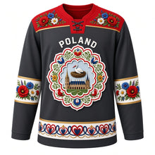 Load image into Gallery viewer, Poland Original Hockey Jersey in Tatra Charcoal, front view – Zalipie flower yoke and wycinanki paper-cut stork crest with ornate detailed artwork, custom name and number