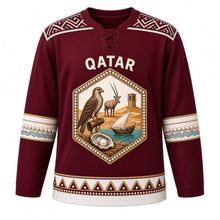 Load image into Gallery viewer, Qatar Original Hockey Jersey in Dhow Burgundy, front view – Al Sadu weave yoke and pearl-studded falcon and oryx crest with ornate detailed artwork, custom name and number