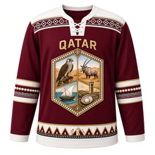 Load image into Gallery viewer, Qatar Original Hockey Jersey in Sadu Maroon, front view – Al Sadu weave yoke and pearl-studded falcon and oryx crest with ornate detailed artwork, custom name and number