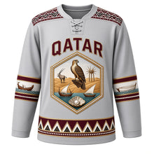 Load image into Gallery viewer, Qatar Original Hockey Jersey in Falcon Silver, front view – Al Sadu weave yoke and pearl-studded falcon and oryx crest with ornate detailed artwork, custom name and number