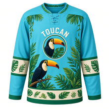 Load image into Gallery viewer, Rainforest Toucan Original Hockey Jersey in Tropical Lagoon, front view – bright toucan perched among tropical rainforest leaves with toucan crest, custom name and number