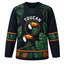 Load image into Gallery viewer, Rainforest Toucan Original Hockey Jersey in Rainforest Night, front view – bright toucan perched among tropical rainforest leaves with toucan crest, custom name and number