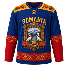Load image into Gallery viewer, Romania Original Hockey Jersey in Carpathian Blue, front view – ie-embroidery yoke and carved Maramures-gate crest with ornate detailed artwork, custom name and number