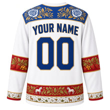 Load image into Gallery viewer, Russia Original Hockey Jersey in Birch White, back view with your name and number – Gzhel-painted yoke and Khokhloma berry sleeve bands