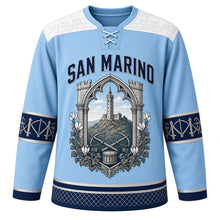Load image into Gallery viewer, San Marino Original Hockey Jersey in Titano Sky Blue, front view – battlement-stone yoke and gothic-arch Mount Titano tower crest with ornate detailed artwork, custom name and number