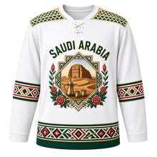 Load image into Gallery viewer, Saudi Arabia Original Hockey Jersey in Pearl White, front view – Al-Qatt geometric yoke and octagonal AlUla Elephant Rock crest with ornate detailed artwork, custom name and number