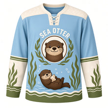 Load image into Gallery viewer, Sea Otter Kelp Forest Original Hockey Jersey in Pacific Blue, front view – sea otter floating among kelp with a seashell and sea-otter crest, custom name and number