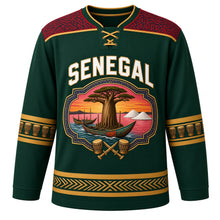 Load image into Gallery viewer, Senegal Original Hockey Jersey in Casamance Forest, front view – baobab and painted-pirogue cartouche crest under SENEGAL lettering, ornate indigo-pattern yoke and detailed artwork, custom name and number