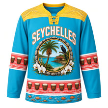 Load image into Gallery viewer, Seychelles Original Hockey Jersey in Lagoon Blue, front view – coco de mer palm and black parrot medallion under SEYCHELLES lettering, ornate orchid-frond yoke and detailed artwork, custom name and number