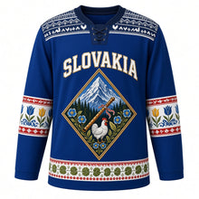 Load image into Gallery viewer, Slovakia Original Hockey Jersey in Danube Blue, front view – Cicmany folk-ornament yoke and diamond crest with Krivan peak and fujara flute, ornate detailed artwork, custom name and number