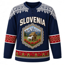 Load image into Gallery viewer, Slovenia Original Hockey Jersey in Adriatic Blue, front view – Idrija lace yoke and honeycomb crest with Lipizzaner horse, kozolec hayrack and honey bees, ornate detailed artwork, custom name and number
