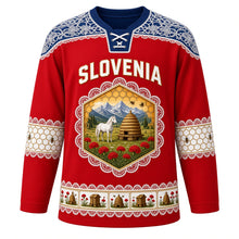 Load image into Gallery viewer, Slovenia Original Hockey Jersey in Carnation Red, front view – Idrija lace yoke and honeycomb crest with Lipizzaner horse, kozolec hayrack and honey bees, ornate detailed artwork, custom name and number