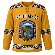 Load image into Gallery viewer, South Africa Original Hockey Jersey in Highveld Gold, front view – Ndebele-pattern yoke and stepped-gable crest with Table Mountain, baobab and blue crane, ornate detailed artwork, custom name and number
