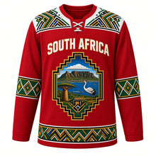 Load image into Gallery viewer, South Africa Original Hockey Jersey in Cape Sunset Red, front view – Ndebele-pattern yoke and stepped-gable crest with Table Mountain, baobab and blue crane, ornate detailed artwork, custom name and number