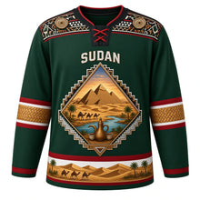 Load image into Gallery viewer, Sudan Original Hockey Jersey in Date Palm Green, front view – ornate pyramid-shaped crest with Meroe pyramids, camel caravan and Nile confluence, Nubian painted yoke, detailed artwork, custom name and number