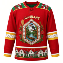 Load image into Gallery viewer, Suriname Original Hockey Jersey in Faya Lobi Red, front view – ornate gabled tembe-carved crest with rainforest canoe, kiskadee and faya lobi flowers, pangi yoke, detailed artwork, custom name and number