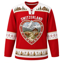 Load image into Gallery viewer, Switzerland Original Hockey Jersey in Matterhorn Red, front view – ornate heart-shaped papercut crest with Matterhorn, chalet, cowbells and alphorns, detailed artwork, custom name and number