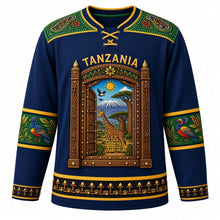 Load image into Gallery viewer, Tanzania Original Hockey Jersey in Zanzibar Blue, front view – ornate Zanzibar carved-door crest with Kilimanjaro and giraffe in Tingatinga style, detailed artwork, custom name and number