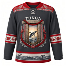 Load image into Gallery viewer, Tonga Original Hockey Jersey in Volcanic Charcoal, front view – ornate trilithon gateway crest with heilala garland and breaching humpback whale, ngatu tapa yoke, detailed artwork, custom name and number