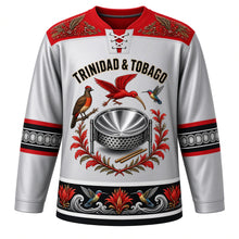 Load image into Gallery viewer, Trinidad and Tobago Original Hockey Jersey in Chrome Pan Silver, front view – ornate steelpan crest with scarlet ibis, cocrico and chaconia, carnival-plumage yoke, detailed artwork, custom name and number