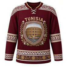 Load image into Gallery viewer, Tunisia Original Hockey Jersey in El Jem Garnet, front view – ornate Roman mosaic plaque crest with El Jem amphitheatre, jasmine and olive branch, detailed artwork, custom name and number