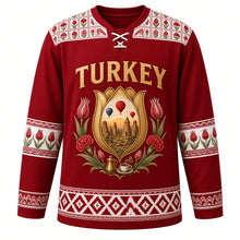 Load image into Gallery viewer, Turkey Original Hockey Jersey in Tulip Crimson, front view – ornate tulip-shaped crest with Cappadocia fairy chimneys, balloons and Iznik flowers, detailed artwork, custom name and number