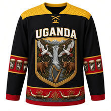 Load image into Gallery viewer, Uganda Original Hockey Jersey in Crane Black, front view – ornate barkcloth-banner crest with dancing crowned cranes, Murchison Falls and Ankole cattle, detailed artwork, custom name and number