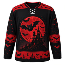 Load image into Gallery viewer, Ugly Halloween Vampire Bat Night Hockey Jersey in Midnight Black, front view – midnight black body with red yoke with a round vampire-bat crest with a huge full moon, a crooked castle and a faceless caped silhouette, bat yoke, bat-wing sleeve bands and a bat and moon hem band – custom name and number