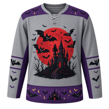 Load image into Gallery viewer, Ugly Halloween Vampire Bat Night Hockey Jersey in Graveyard Gray, front view – graveyard gray body with purple yoke with a round vampire-bat crest with a huge full moon, a crooked castle and a faceless caped silhouette, bat yoke, bat-wing sleeve bands and a bat and moon hem band – custom name and number