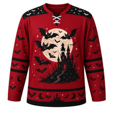 Load image into Gallery viewer, Ugly Halloween Vampire Bat Night Hockey Jersey in Blood Moon Red, front view – blood moon red body with black yoke with a round vampire-bat crest with a huge full moon, a crooked castle and a faceless caped silhouette, bat yoke, bat-wing sleeve bands and a bat and moon hem band – custom name and number