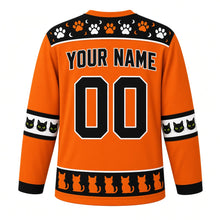 Load image into Gallery viewer, Ugly Halloween Black Cat Curse Hockey Jersey in Pumpkin Orange, back view with a paw print and skull yoke, witch broom sleeve bands, black cat hem band, arched YOUR NAME lettering and 00 – custom name and number
