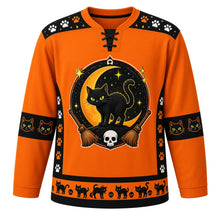 Load image into Gallery viewer, Ugly Halloween Black Cat Curse Hockey Jersey in Pumpkin Orange, front view – pumpkin orange body with an arched hissing black cat with glowing eyes on a crescent moon crest with witch brooms, magic sparkles, tiny cartoon skulls and paw prints, paw print yoke, broom sleeve bands and a black cat hem band – custom name and number