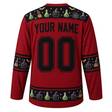 Load image into Gallery viewer, Ugly Halloween Witches Cauldron Hockey Jersey in Blood Moon Red, back view with a potion bottle and spider web yoke, broom and witch hat sleeve bands, cauldron hem band, arched YOUR NAME lettering and 00 – custom name and number