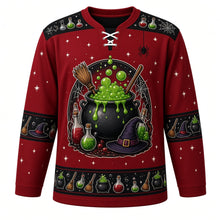 Load image into Gallery viewer, Ugly Halloween Witches Cauldron Hockey Jersey in Blood Moon Red, front view – blood moon red body with black yoke with a round bubbling witches cauldron crest with green brew, potion bottles, broom, witch hat and spiders, potion yoke, broom and hat sleeve bands and a cauldron hem band – custom name and number