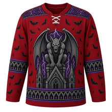 Load image into Gallery viewer, Ugly Halloween Gargoyle Cathedral Hockey Jersey in Blood Moon Red, front view – blood moon red body with a winged stone gargoyle with glowing eyes crest on a gothic spire with stained-glass rose windows, rain, lightning and bats, rose window yoke, gothic arch sleeve bands and a spire hem band – custom name and number