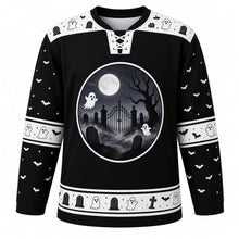 Load image into Gallery viewer, Ugly Halloween Graveyard Ghosts Hockey Jersey in Midnight Black, front view – midnight black body with bone white yoke with a round moonlit graveyard crest of floating ghosts, tombstones, bare tree and bats, ghost yoke, ghost and bat sleeve bands and a tombstone hem band – custom name and number