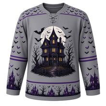 Load image into Gallery viewer, Ugly Halloween Haunted House Hill Hockey Jersey in Graveyard Gray, front view – graveyard gray body with a haunted Victorian house on a hill crest with glowing windows, creepy eyes, full moon, bats and dead trees, bat yoke, haunted house sleeve bands and a glowing window hem band – custom name and number