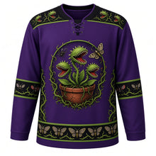Load image into Gallery viewer, Ugly Halloween Carnivorous Plant Garden Hockey Jersey in Venom Purple, front view – venom purple body with poison green and black trim with a crest of snapping carnivorous flytrap plants with jagged teeth and glowing eyes in a clay pot ringed by thorny vines, a spider and a moth, flytrap-and-thorn yoke and moth-patterned stripe bands – custom name and number
