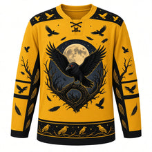 Load image into Gallery viewer, Ugly Halloween Midnight Raven Roost Hockey Jersey in Harvest Moon Gold, front view – harvest moon gold body with black yoke with a red-eyed raven with spread wings on a gnarled branch before a full moon, a flock of crows and crooked trees, crow-flock yoke, feather sleeve bands and a tree-silhouette hem band – custom name and number
