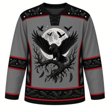 Load image into Gallery viewer, Ugly Halloween Midnight Raven Roost Hockey Jersey in Graveyard Gray, front view – graveyard gray body with black yoke with a red-eyed raven with spread wings on a gnarled branch before a full moon, a flock of crows and crooked trees, crow-flock yoke, feather sleeve bands and a tree-silhouette hem band – custom name and number