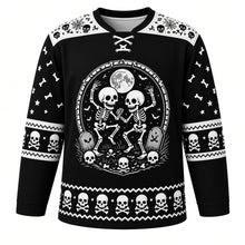 Load image into Gallery viewer, Ugly Halloween Rattling Skeletons Hockey Jersey in Midnight Black, front view – midnight black body with bone-white yoke with a round dancing-skeletons crest with full moon, skulls, crossed bones, bats and a tombstone, skull yoke, bone sleeve bands and a skull hem band – custom name and number