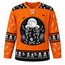 Load image into Gallery viewer, Ugly Halloween Rattling Skeletons Hockey Jersey in Pumpkin Orange, front view – pumpkin orange body with black yoke with a round dancing-skeletons crest with full moon, skulls, crossed bones, bats and a tombstone, skull yoke, bone sleeve bands and a skull hem band – custom name and number