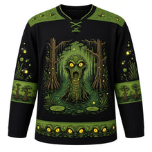 Load image into Gallery viewer, Ugly Halloween Swamp Creature Bayou Hockey Jersey in Midnight Black, front view – midnight black body with a scaly swamp creature with glowing eyes rising from a murky bayou crest with moss-draped cypress trees, lily pads, fireflies and bubbles, moss yoke, lily pad sleeve bands and a cypress tree hem band – custom name and number
