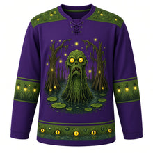 Load image into Gallery viewer, Ugly Halloween Swamp Creature Bayou Hockey Jersey in Witch Purple, front view – witch purple body with a scaly swamp creature with glowing eyes rising from a murky bayou crest with moss-draped cypress trees, lily pads, fireflies and bubbles, moss yoke, lily pad sleeve bands and a cypress tree hem band – custom name and number