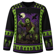 Load image into Gallery viewer, Ugly Halloween Zombie Shuffle Hockey Jersey in Midnight Black, front view – midnight black body with green yoke with goofy cartoon zombies shuffling from cracked earth with rising hands, tombstones and crows, zombie-hand yoke, zombie-hand sleeve bands and a tombstone hem band – custom name and number