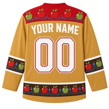 Load image into Gallery viewer, Ugly Thanksgiving Apple Bobbing Barrel Hockey Jersey in Cider Gold, back view – cider gold body with apple red yoke of apples on water ripples, apple-and-droplet sleeve bands and hem band, straight YOUR NAME lettering and 00 – custom name and number