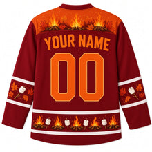 Load image into Gallery viewer, Ugly Thanksgiving Autumn Bonfire Night Hockey Jersey in Cranberry Red, back view with an orange yoke of campfires, sparks and autumn leaves, marshmallow and leaf sleeve bands, a hem of mini campfires and marshmallows, YOUR NAME lettering and 00 – custom name and number
