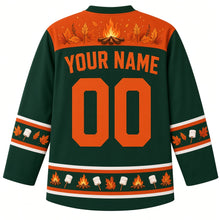 Load image into Gallery viewer, Ugly Thanksgiving Autumn Bonfire Night Hockey Jersey in Spruce Green, back view with an orange yoke of a campfire, sparks and autumn leaves, marshmallow and leaf sleeve bands, a hem of mini campfires, marshmallows and leaves, YOUR NAME lettering and 00 – custom name and number